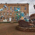 Mural of Annie Glidden and DeKalb landmarks. Located downtown next to the Soldiers and Sailors Memorial Clock.